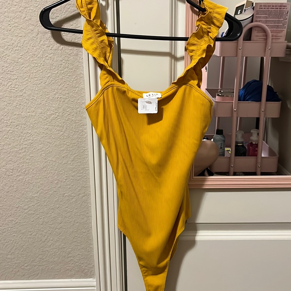 Flattering size small yellow Lelis collection body suit.